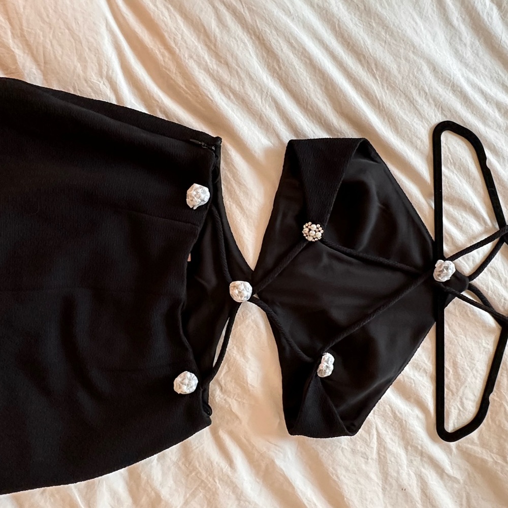 Alexis cut-out black mini dress. Pearl and crystal details in the back